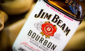 Butelka Jim Beam White Label, z charakterystycznym logo i napisem "Bourbon". Idealna na wieczór z przyjaciółmi.